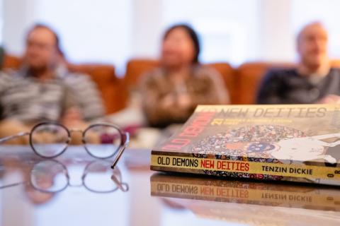 A book "Old Demons New Deities" by Tenzin Dickie lays on a table